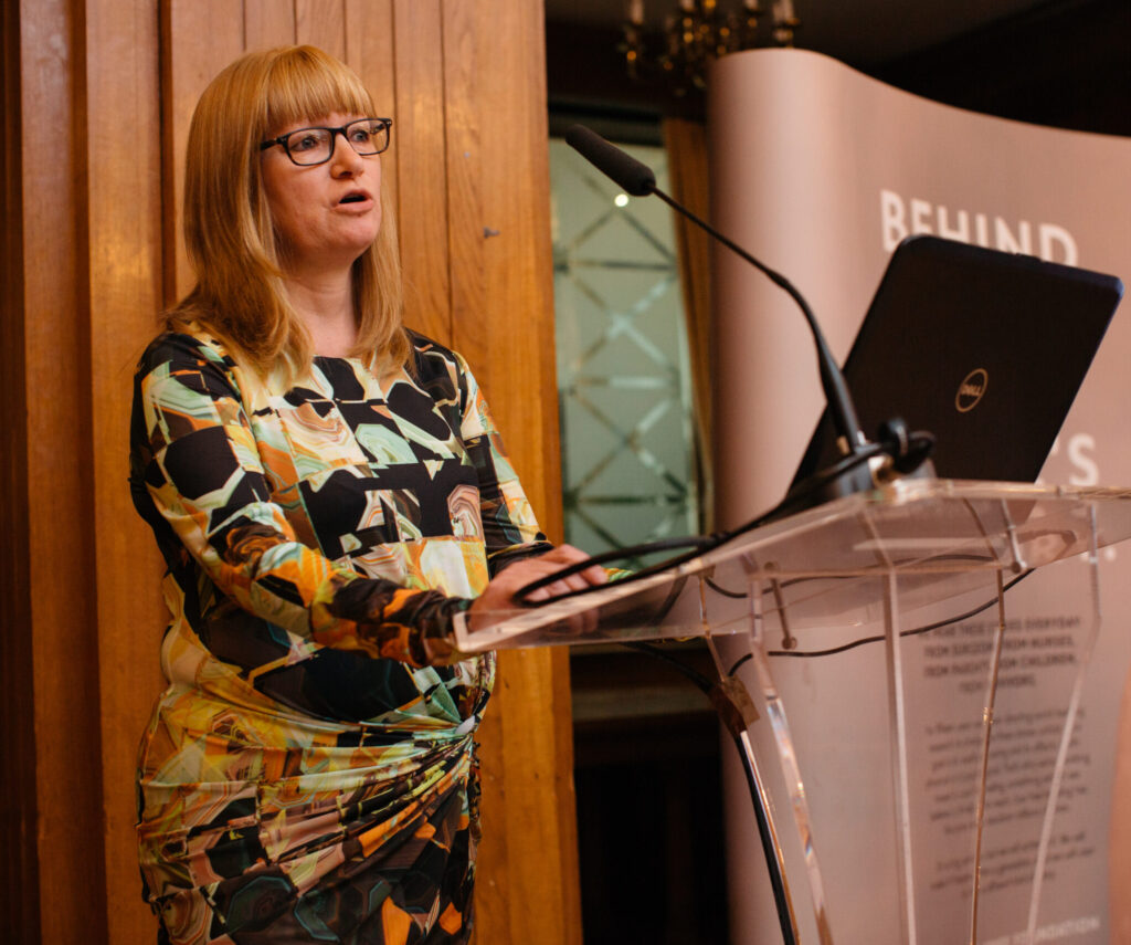 Amber Young was a Consultant Paediatric Anaesthetist and burns researcher. The legacy of her research has changed the way paediatric burns are approached and her work is internationally recognised. In the picture, Amber gives a speech at a lecturn at a Scar Free Foundation event.