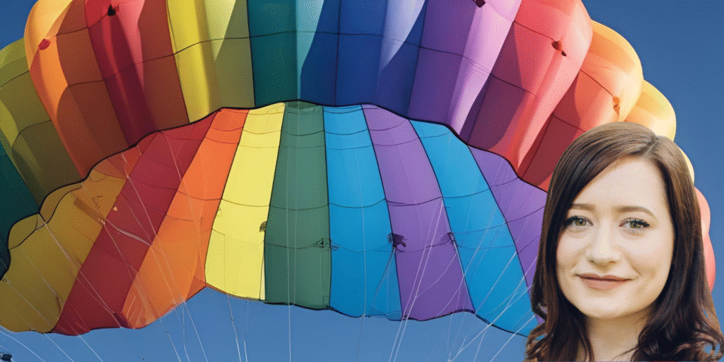 Scar Free Ambassador Lucy in front of a rainbow parachute.
