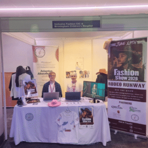 Carmen Burkett and a volunteer at a conference stand during the ICC Conference in April 2026