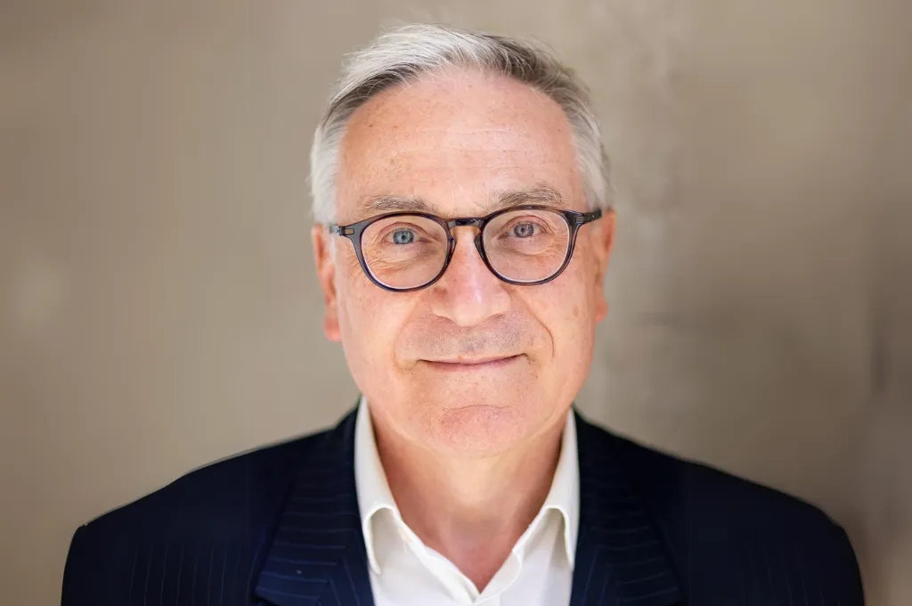 Lieutenant General Richard Nugee, professional headshot wearing glasses and dark blazer with white shirt.