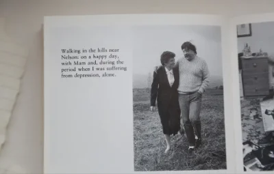 Book with black and white photo of Simon Weston and his mum walking in a grassy field.